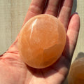 One (1) Medium Peach Selenite Palm Stone from Morocco (~6.5cm)