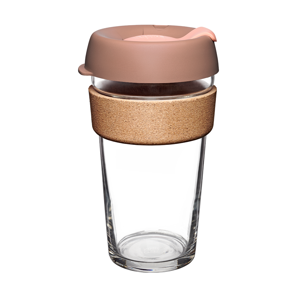 Clear glass reusable cup with a bronze colour lid and wooden sleeve on a white background