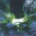 Vinyl record cover with glowing book among green plants, Sub Basics Wavelengths album art