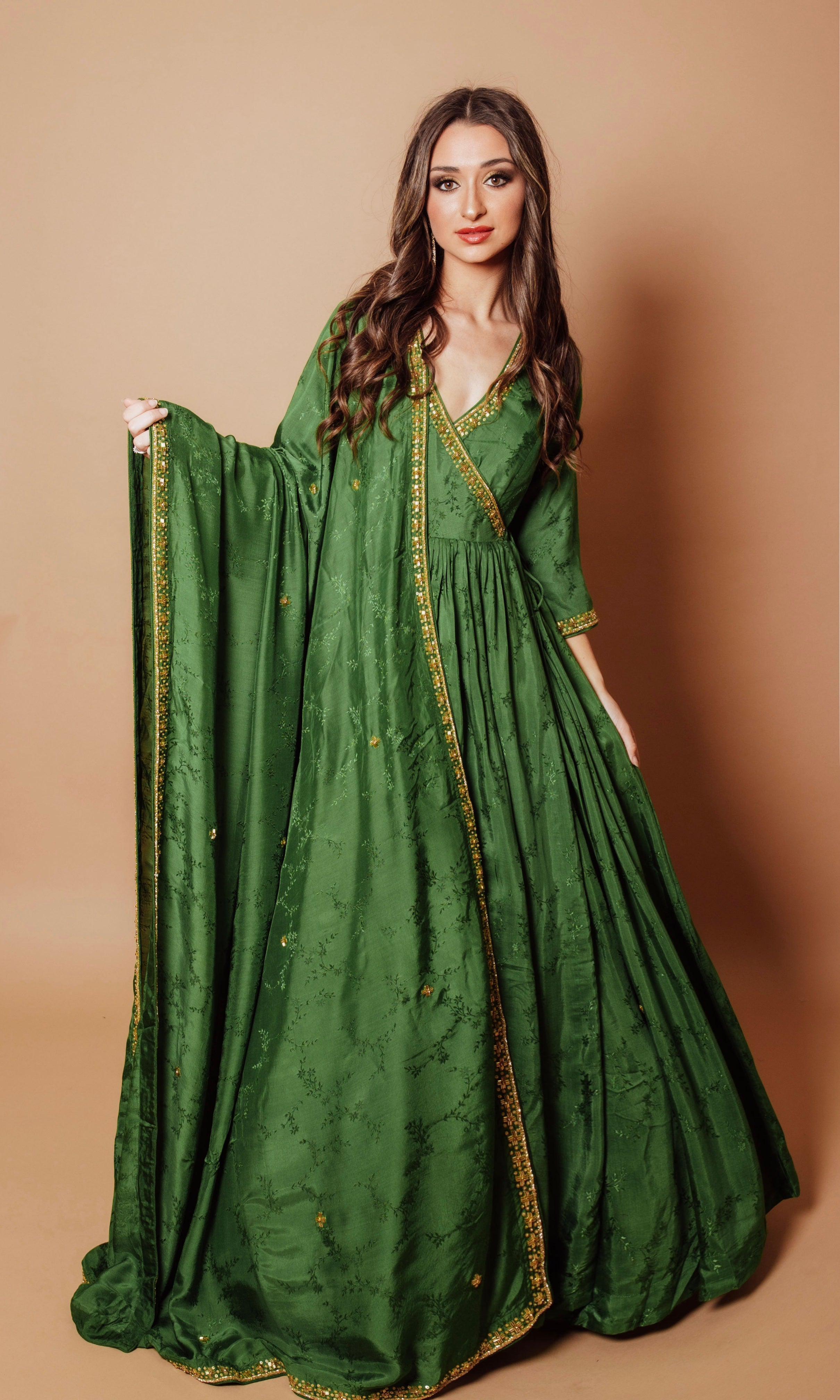 Emerald green silk anarkali gown with tonal floral embroidery, gold cutdana, stones, and sequins.