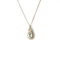 Collar en oro amarillo 10k con aguamarina ovalada con pasacadena y halo de diamantes 0.18ctw