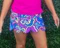 Sweet details meet warm-weather ease in the Scallop Trim Skort – Groovy Garden. A charming scallop hem and flattering pleated silhouette give this skort a polished, feminine finish, while the lightweight UPF 50 fabric keeps you cool and protected whether you’re exploring a new city, heading to brunch, or spending the day outdoors.