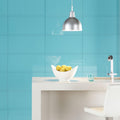 Colorado Clear Glass 600 x 300mm teal glass surface with a white ceramic bowl of lemons