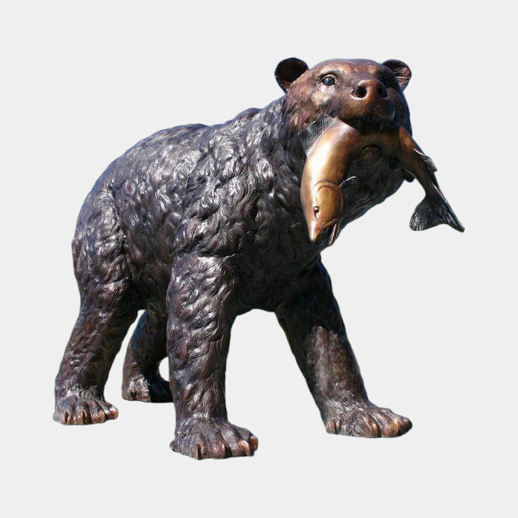 Life-Size Traditional Walking Bear Bronze Sculpture by Giant Sculptures, shown mid-stride with a salmon in its jaws and a dark brown patina against a plain background.
