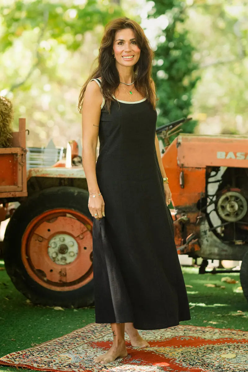Black fit and flare linen dress outdoors among greenery — soft linen-cotton blend drape